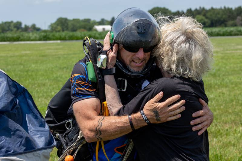 (left to right) Chad Staerkel embraces Kathy Traegar after successfully skydiving together on Friday, July 11, 2025 at Skydive Chicago in Ottawa.