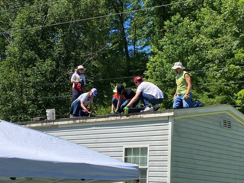 Youth and adults from United Methodist Church of Geneva repair a roof during a 40th annual Appalachia Service Project mission trip to Breathitt County, Ky., July 8-15, 2023.