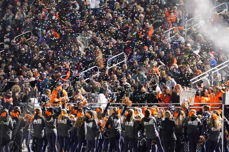 Oswego's shoots confetti into the air right before kick-off against Oswego East during a football game at Oswego High School on Friday, Oct. 20, 2023.