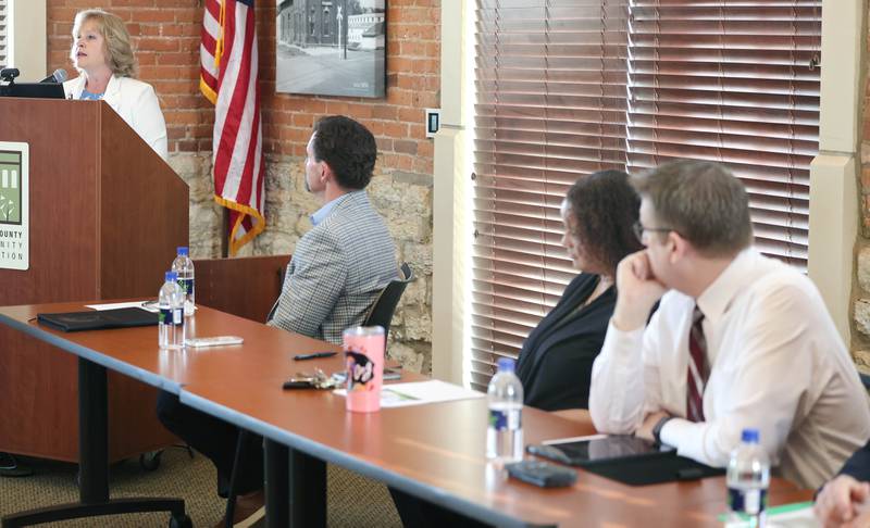 Members of the panel listen as Laurie Borowicz, president of Kishwaukee College, speaks during the State of the Community address Thursday, May 11, 2023, in the DeKalb County Community Foundation Freight Room in Sycamore. The event was hosted by the Sycamore Chamber of Commerce.