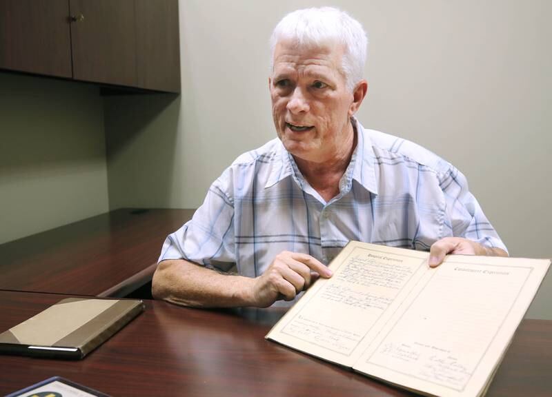 DeKalb resident John Wright talks Monday, Oct. 7, 2024, about some of the stories recounting battles written in WWI U.S. Army soldier Albert Leonhard’s service record book that he purchased at a local estate sale.