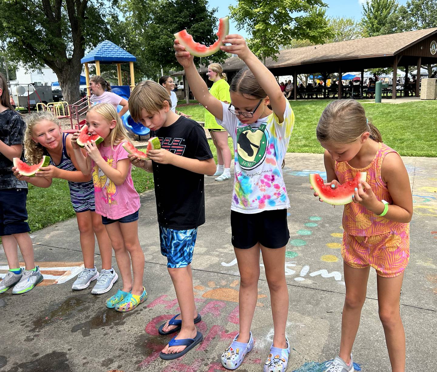 Kennlee Sieber, 9, of Forreston, holds her watermelon rind high as she wins her age division at Forreston's Sauerkraut Days' Watermelon Eating Contest on Saturday, Aug. 3, 2024. Winners of each age division were awarded a medal and a can of Frank's Sauerkraut.