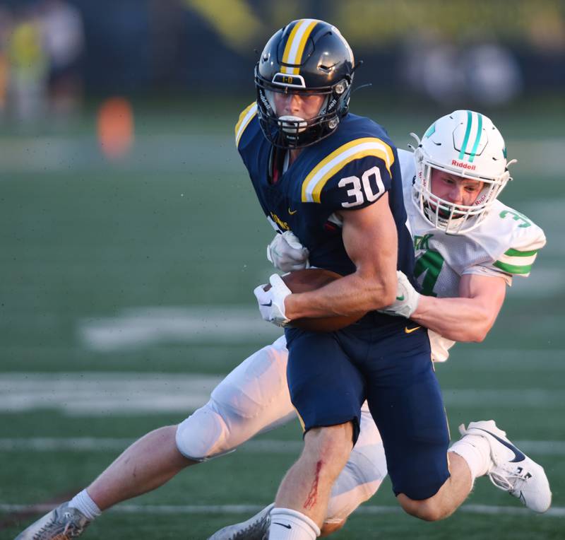 Joe Lewnard/jlewnard@dailyherald.com
Glenbrook South's Dom Reikiewicz, left, gets tackled by York’s Jimmy Conners during a football game played in Glenview, Ill. on Friday, Aug. 25, 2023.