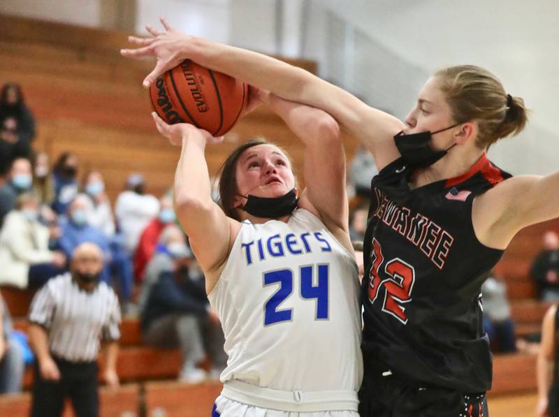 PHS senior McKenzie Hecht tries to shoot despite the presence of Kewanee's Emma Crofton Thursday at Prouty Gym. PHS won 55-45.