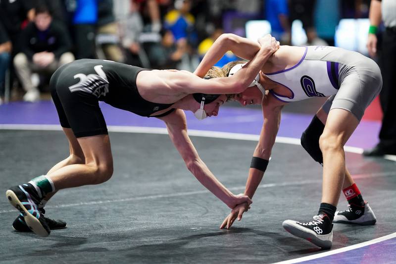 Dixon’s Jack Ragan (left) locks arms with Plano’s Shane Downs during their 113 championship bout in the Plano Reaper Classic Wrestling meet at Plano High School on Saturday, Dec. 14, 2024.