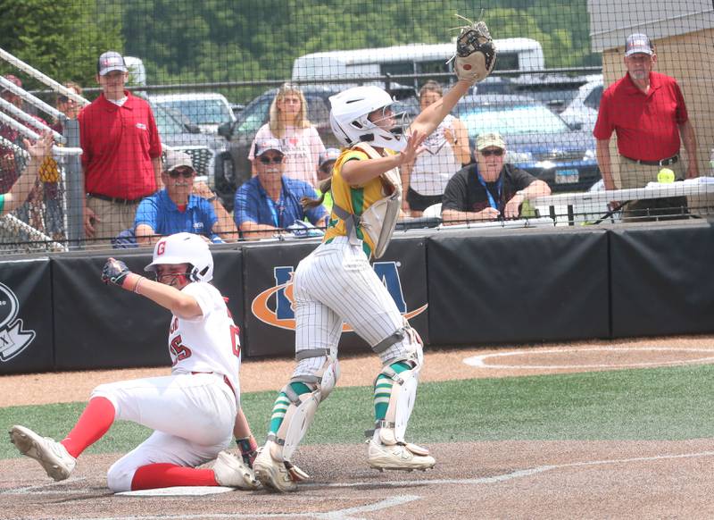 Providence Catholic's catcher Mia Sanfratello steps away from home plate to make a catch at the plate as Chatham's Sophia Feld scores the go ahead run during the Class 3A State finals game on Saturday, June 14, 2025 at the Louisville Slugger Sports Complex in Peoria.