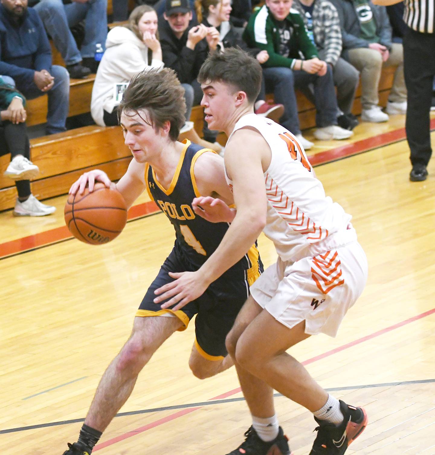 Polo's Brock Soltow drives on a Winnebago player during Saturday action the 61st Forreston Holiday Tournament.