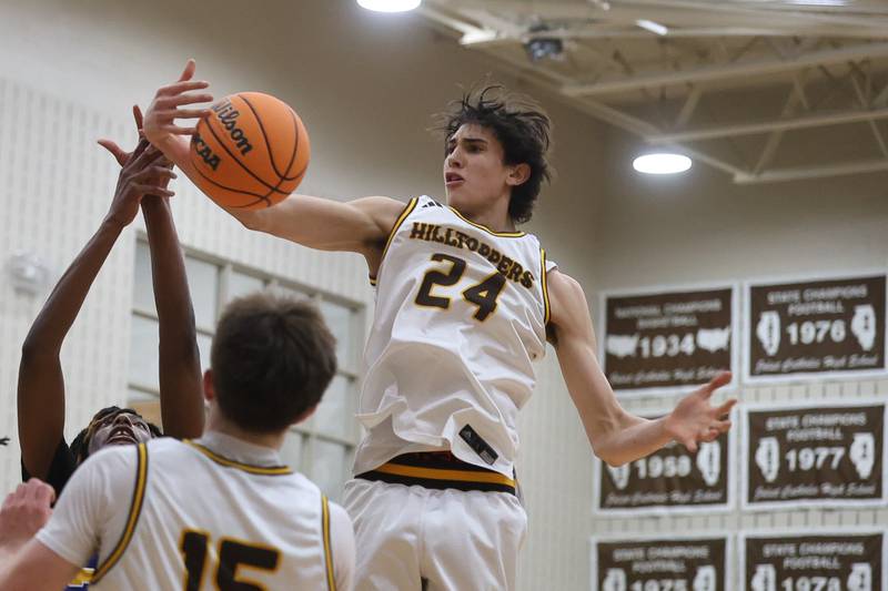 Joliet Catholic’s Elias Passel pulls in a rebound against Joliet Central on Tuesday, Jan 20, 2026 in Joliet.