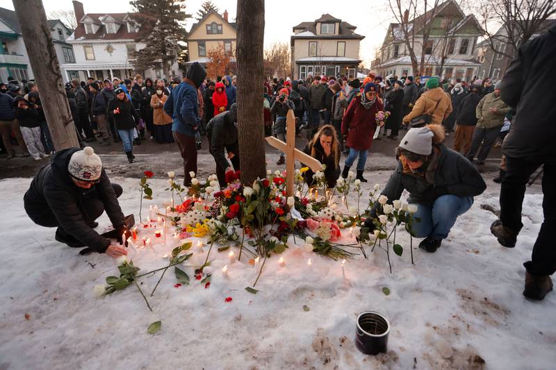 People gather for a vigil after an Immigration and Customs Enforcement officer shot and killed a woman earlier in the day, Wednesday, Jan. 7, 2026, in Minneapolis. (AP Photo/Bruce Kluckhohn)