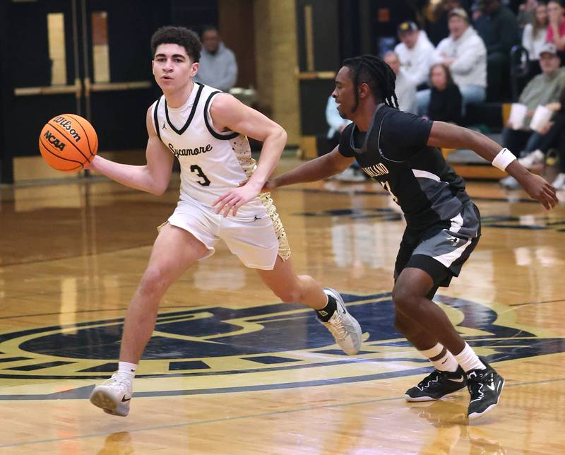 Sycamore's Marcus Johnson passes the ball around Kaneland's Marshawn Cocroft during their game Friday, Jan. 9, 2025, at Sycamore High School.