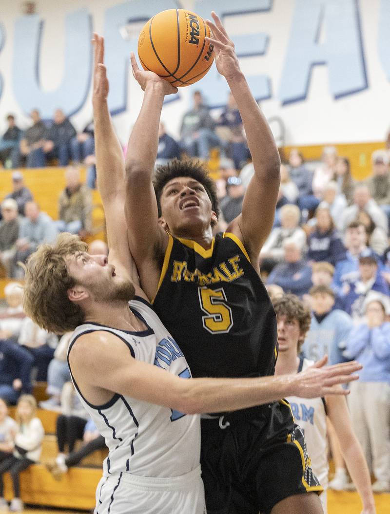Riverdale’s Aris Morgan works below the basket against Bureau Valley’s Landon Hulsing Wednesday, Feb. 26, 2025, at the Class 2A Regional semifinal at Bureau Valley High School.