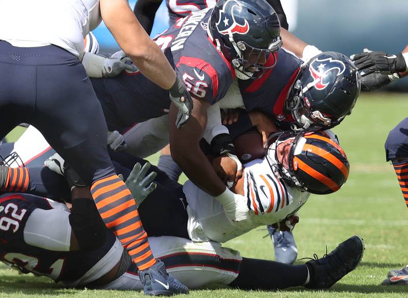 Chicago Bears quarterback Justin Fields is sacked by Houston Texans defensive end Jerry Hughes and defensive end Rasheem Green during their game Sunday, Sept. 25, 2022, at Soldier Field in Chicago.
