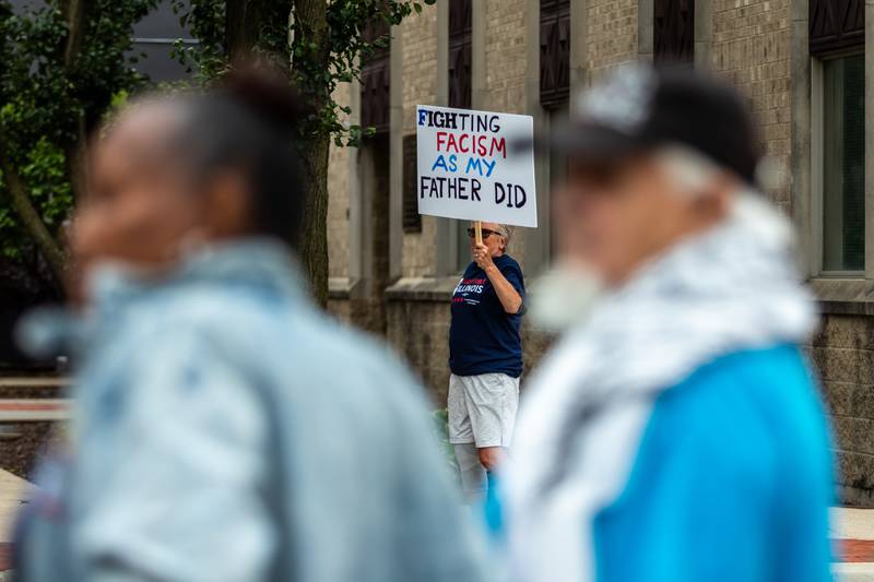 An attendee holds up a sign at the Good Trouble Lives On event in Downtown Joliet on July 17, 2025.