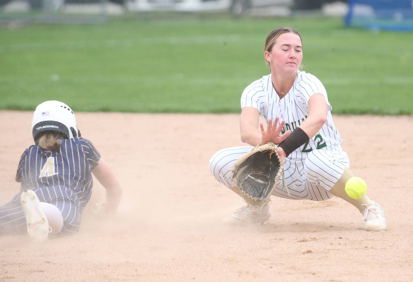 St. Bede's Ella Hermes catches the ball as Marquette's Hunter Hopkins slides safely into second base on Thursday, April 18, 2024 in Ottawa.