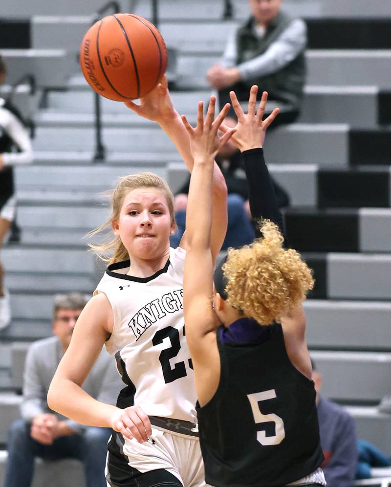 Kaneland’s Kendra Brown throws a pass over Plano's Maddy Leftridge during their game Tuesday, Dec. 13, 2022, at Kaneland High School in Maple Park.