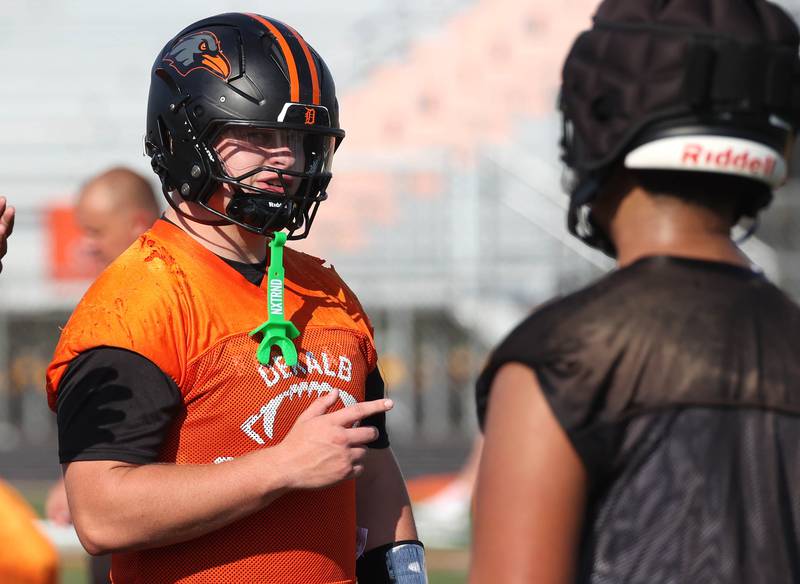 DeKalb’s Owen Sisson talks to a teammate Monday, Aug. 11, 2025, during their first fall practice at the school.
