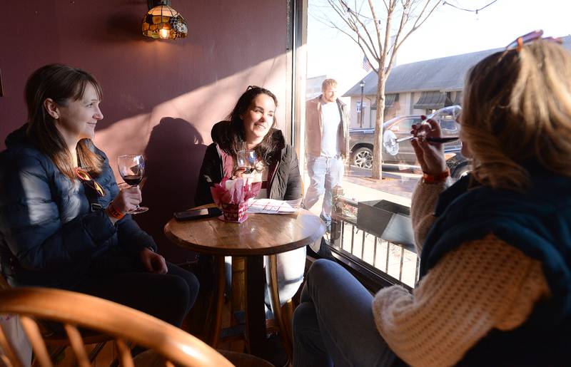 Wheaton residents and attendees of the Winter Wine and Cheese Walk (left-right) Liz Byrne, Alayne Fahrman and Chela Marshall enjoy time together and the event inside Tasting deVine  Saturday, Feb 3, 2024.
