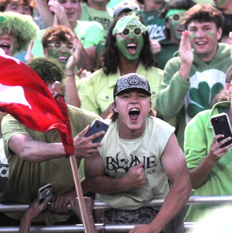 Student sections at the Ottawa versus Streator football game wear green for Ottawa player Michael Mills at King Field on Friday, Sept. 1, 2023.