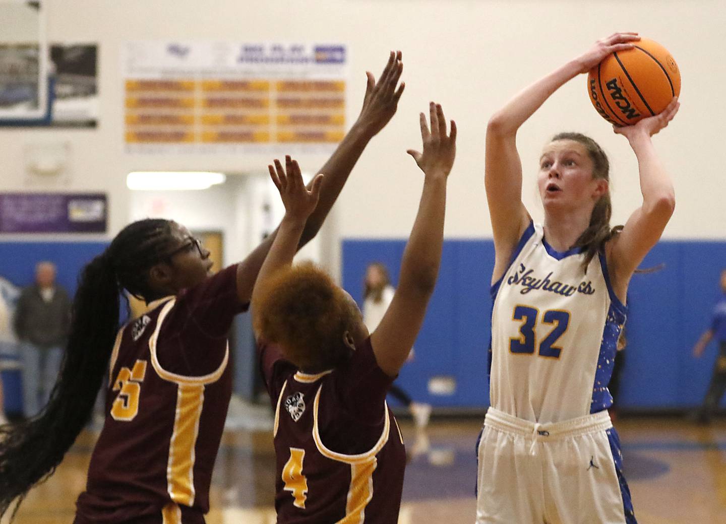 Johnsburg's Skye Toussaint (right) shoots th ball over Chicago Marshall's Chamarre Scott (left) and Lanyla Sago (center) during a IHSA Class 2A Johnsburg Sectional girls basketball semifinal game on Tuesday, February, 24, 2026, at Johnsburg High School.