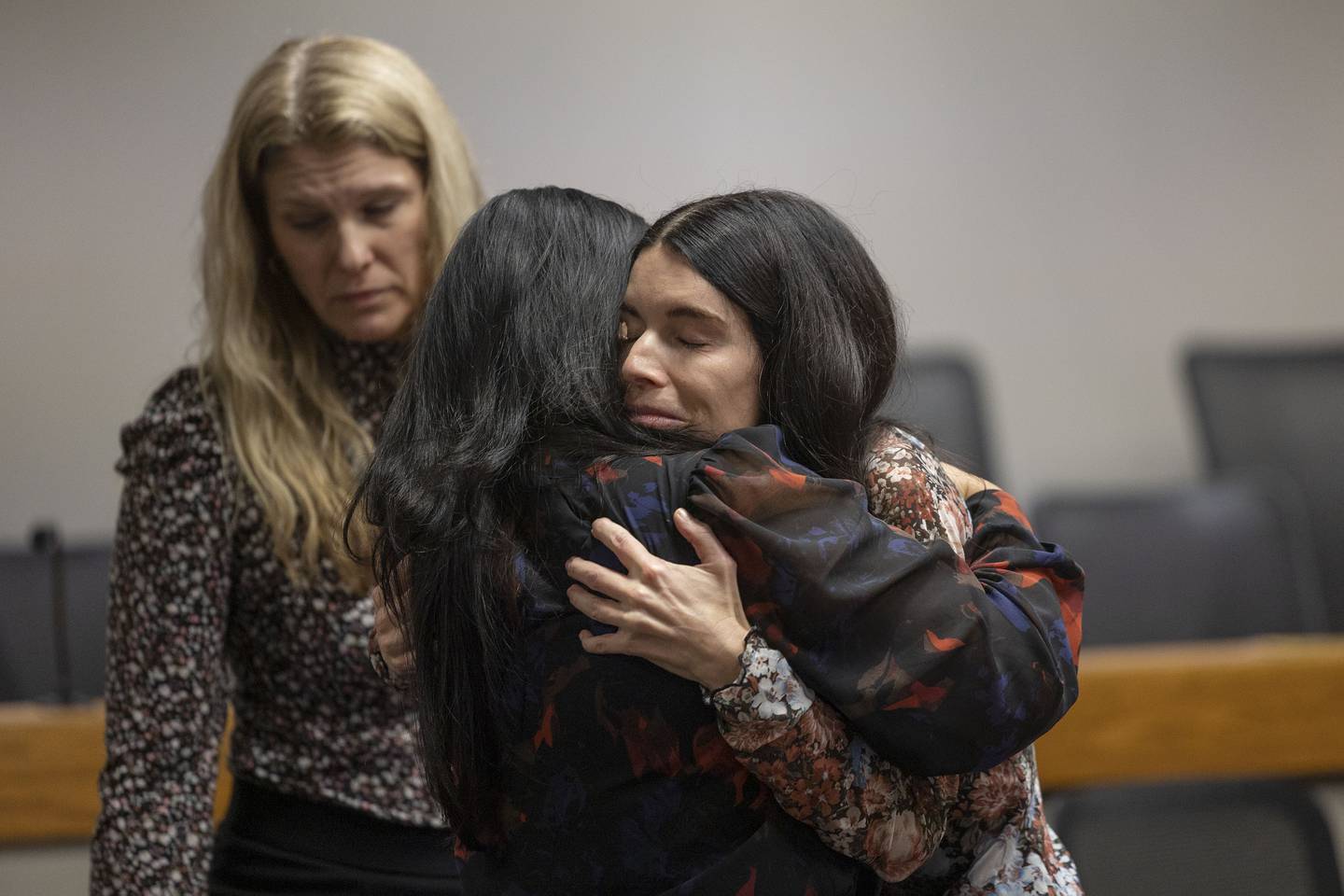 Brittney Ramos is hugged by supporters Friday, Nov. 14, 2025, after a jury awarded her $31.5 million for the wrongful death of her husband, firefighter Garrett Ramos.