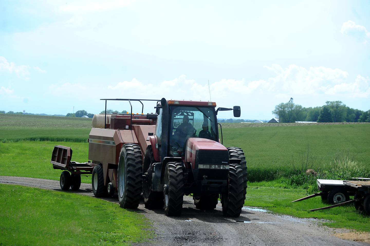Farmer Bryon Kelly brings his tracker and baler to his fuel storage tank to fill up the tractor with diesel fuel Friday, June 10, 2022, after baling hay on his farm near Richmond. The rising cost of nitrate and fuels is raising farmers' operational costs.