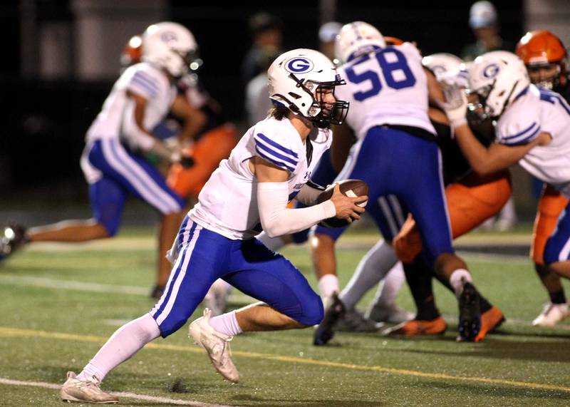 Geneva quarterback Nate Stempowski keeps the ball for a touchdown during a game at Wheaton Warrenville South on Friday, Sept. 16, 2022.