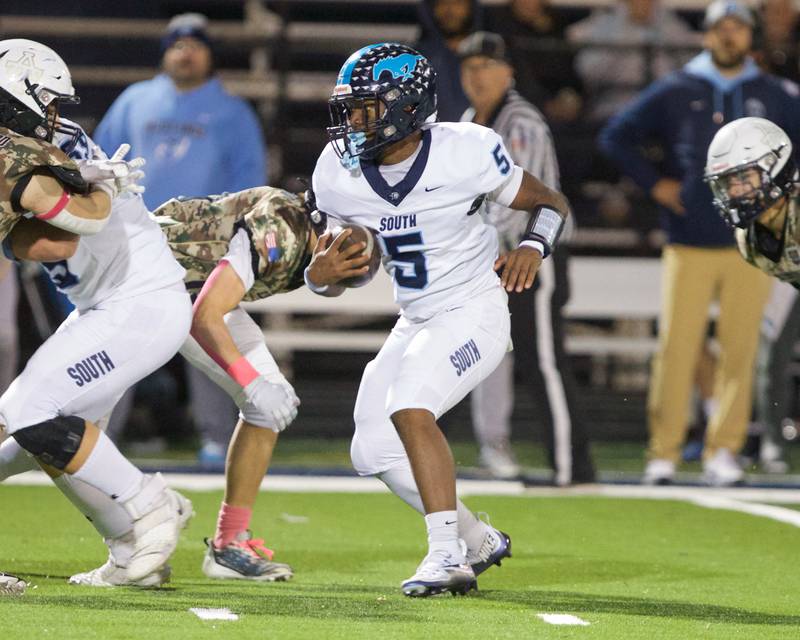 Downers Grove South's Kayden Smith runs the ball for a gain against Addison Trail on Friday, Oct.25,2024 in Addison.