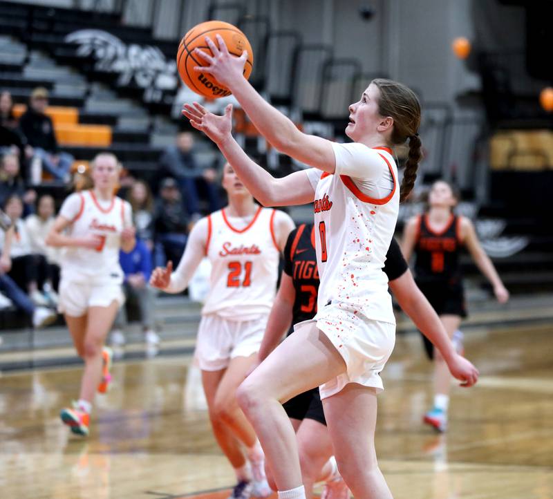 St. Charles East's Kathlyn Bainbridge gets a shot up during a game against Wheaton Warrenville South on Tuesday, Feb. 11, 2025 in St. Charles.