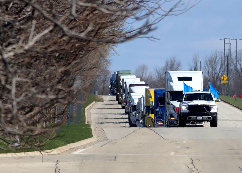 Drivers travel on Beverly Road in Hoffman Estates on Saturday morning as they begin the Deblockade Mariupol truck protest rally hosted by Help Ukraine Foundation LTD to bring attention to the blockade of Mariupol.