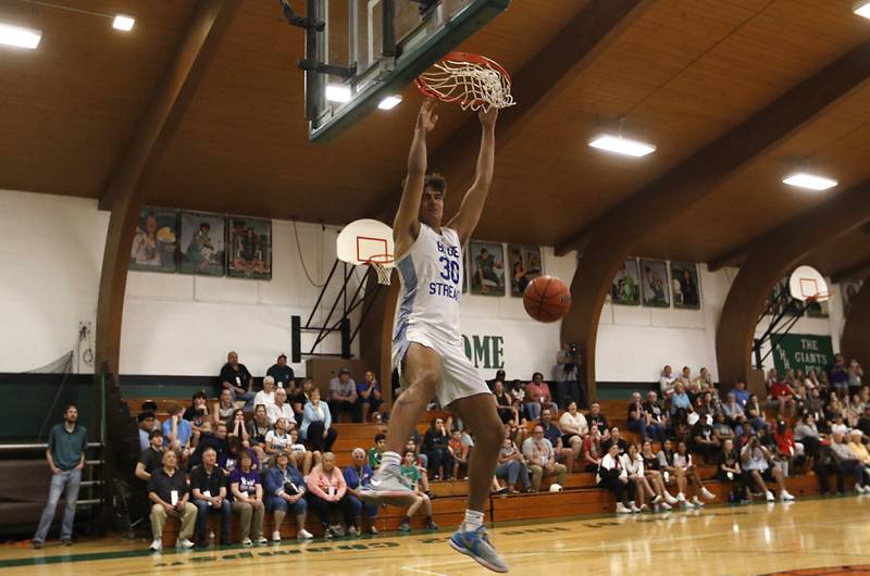 Woodstock's Spencer Cullum dunks the basketball during the dunk contest of McHenry County Area All-Star Basketball Extravaganza on Sunday, April 14, 2024, at Alden-Hebron’s Tigard Gymnasium in Hebron.