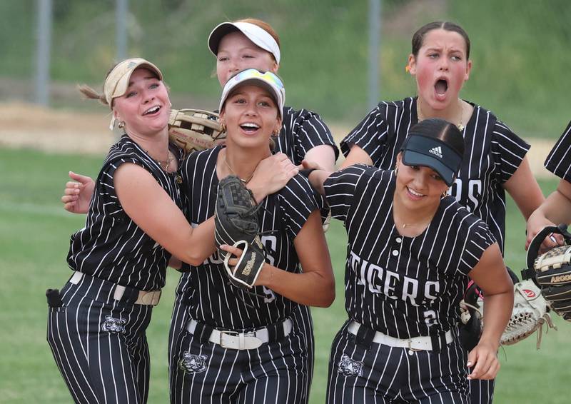 Crystal Lake Central's Brooklyn Johnson is mobbed by her teammates after making a diving catch for the third out to prevent Sycamore, who had runners on base, from scoring Tuesday, June 3, 2025 during their Class 3A sectional semifinal game at Sycamore High School.