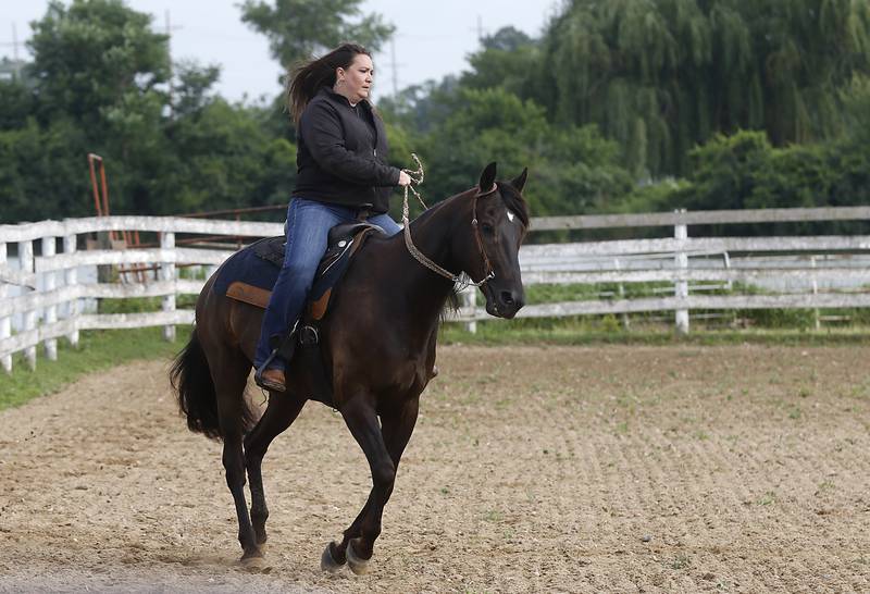 Brigette Birong rides Danta, retired Medieval Times horse Friday July, 8, 2022, at the R Double J Ranch, 2800 Derby Lane, in McHenry. The R Double J Ranch recently got the contract to operate this equine facility from McHenry with the goal of making it more of a community-centric center and make learning about horses and riding open to all.