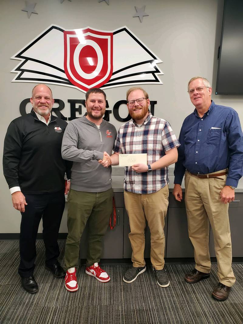 OCUSD 220 Superintendent Tom Mahoney, Oregon Elementary School Assistant Principal Ryan Huels, Oregon Church of God Assistant Pastor Nathan Massey, and Oregon Church of God Pastor Michael Hoffman pose with the donation.