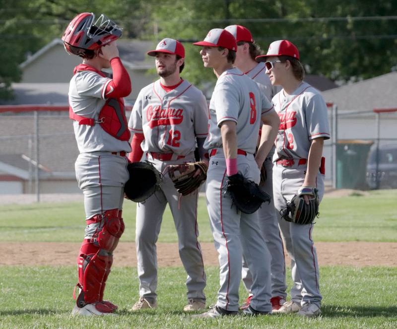 Members of the Ottawa baseball team gather on the infield while playing Streator on Tuesday, May 16, 2023 at Streator High School.