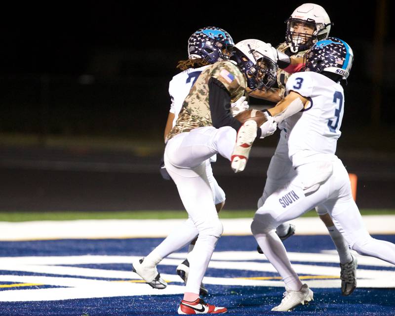 Addison Trails Raja Corhn intercepts the ball in  Downers Grove South's end zone 
 on Friday, Oct.25,2024 in Addison.