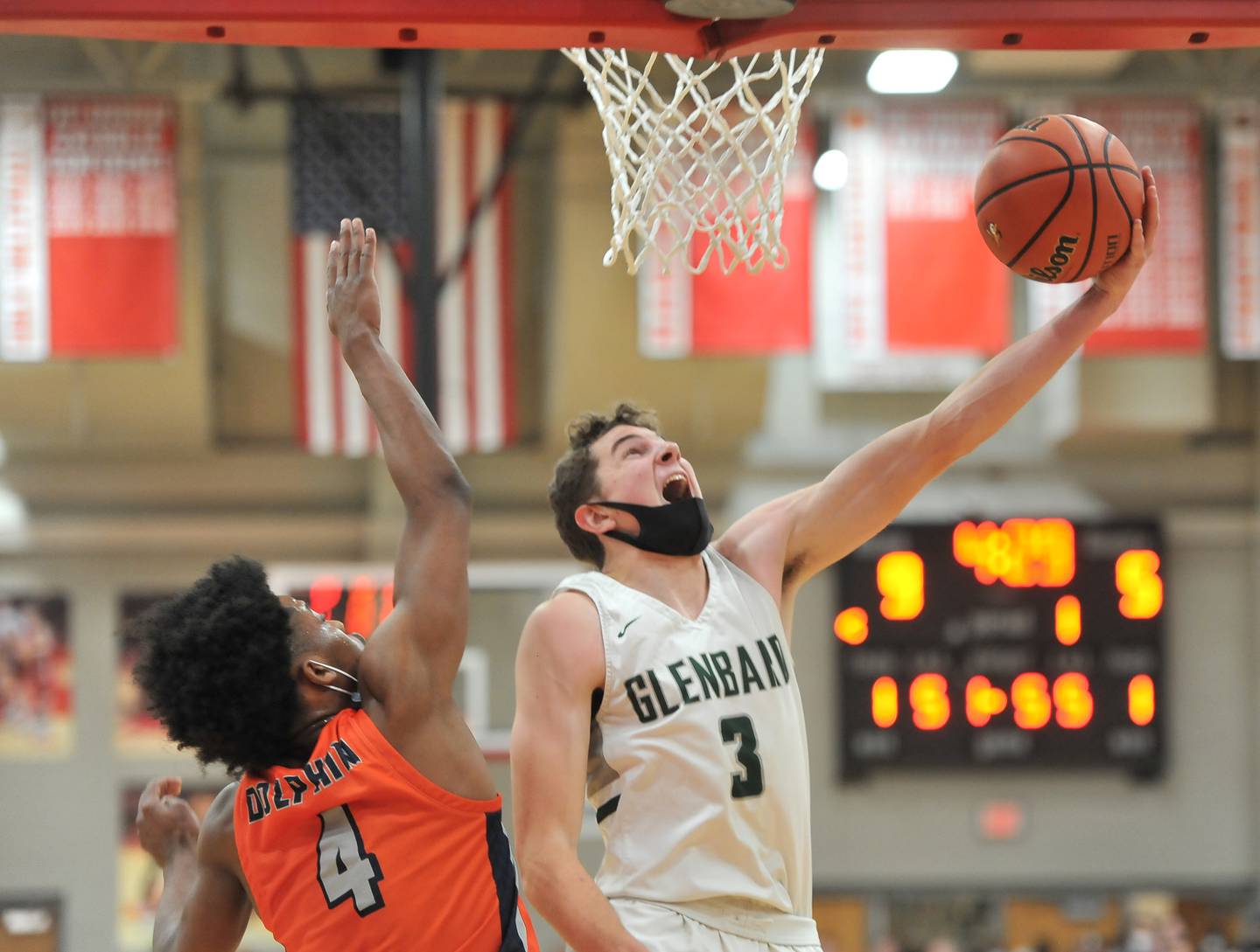 Glenbard West's Caden Pierce (3) does a reverse layup in front of Whitney Young's Marcus Pigram (4) during a game on Jan. 22, 2022 at Benet Academy in Lisle.