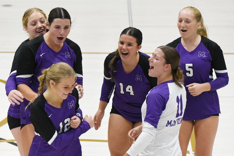 Members of the Manteno girls volleyball team celebrate after a point from Maddy Belisle (12) during the Panthers' 2-1 win at Bishop McNamara Monday, Oct. 20, 2025.