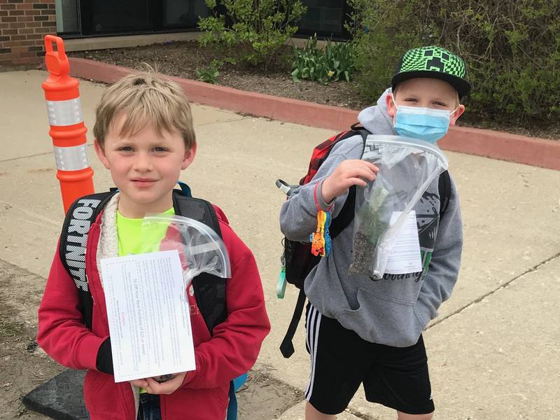 Coventry Elementary School second-grade students Logan Pierce, left, and Cason Mogilinski received a free tree sapling Friday, April 29, 2022, in honor of Arbor Day.