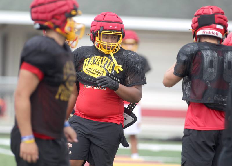 Batavia newcomer Malachi Smith (center) runs a drill with his team during practice at the school on Thursday, Aug. 10, 2023.