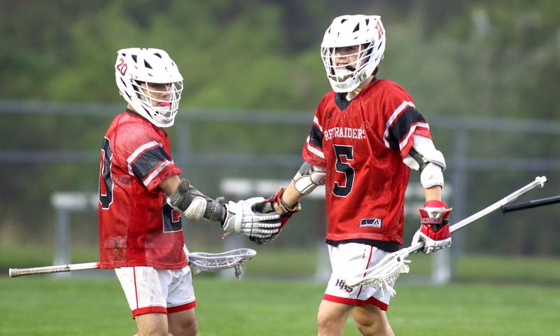 Huntley’s Nick Toman, right, and Cameron Abordo celebrate a Red Raider goal in varsity boys lacrosse at Prairie Ridge  High School in Crystal Lake on Thursday, May 1, 2025.