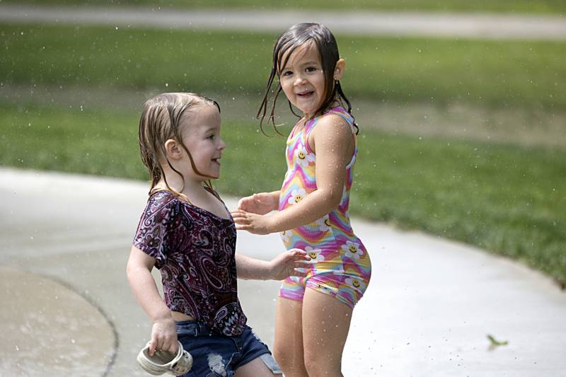 Rebecca Bellows (left), 3, and Emma Farnham, 4, enjoy Sterling’s new splash pad at the Grandon Civic Center Wednesday, May 31, 2023. The new pad is open 9 a.m. to 8 p.m. except on days of a Municipal Band concert.Wednesday, May 31, 2023.