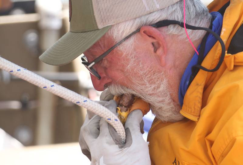 71 year old adventurer and thyroid cancer survivor Robert Youens, munches on a burger from Skoogs while locking at the Starved Rock Lock and Dam on Monday, July 28, 2025 near Utica. Youens is making  the Great Loop, a 6,000 mile journey on his Jon boat something that hasn't been done before. Youens is looking at setting a record for the longest someone has gone on a Jon boat.