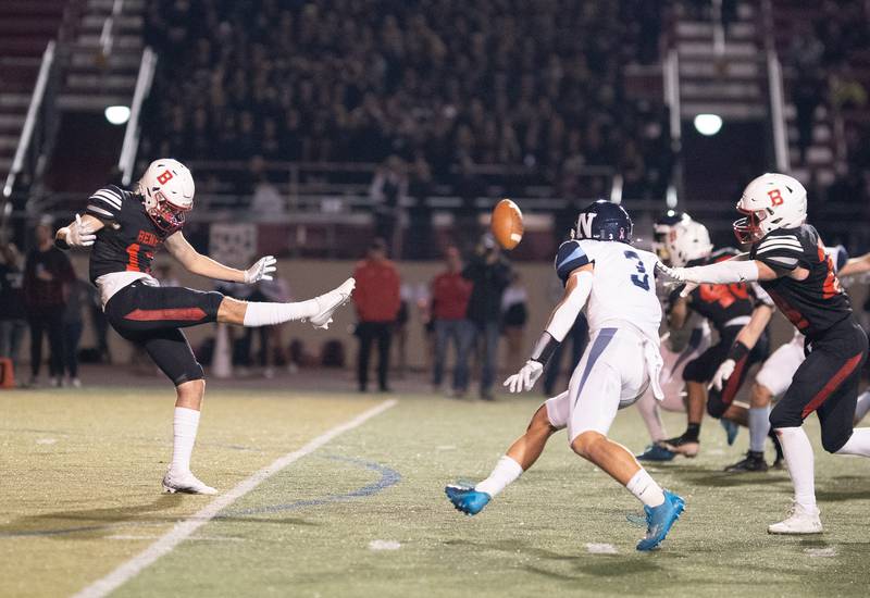 Benet Academy's Ahren Becker (13) punts the ball against Nazareth Academy during a football game at Benedictine University in Lisle on Friday, Oct 21, 2022.