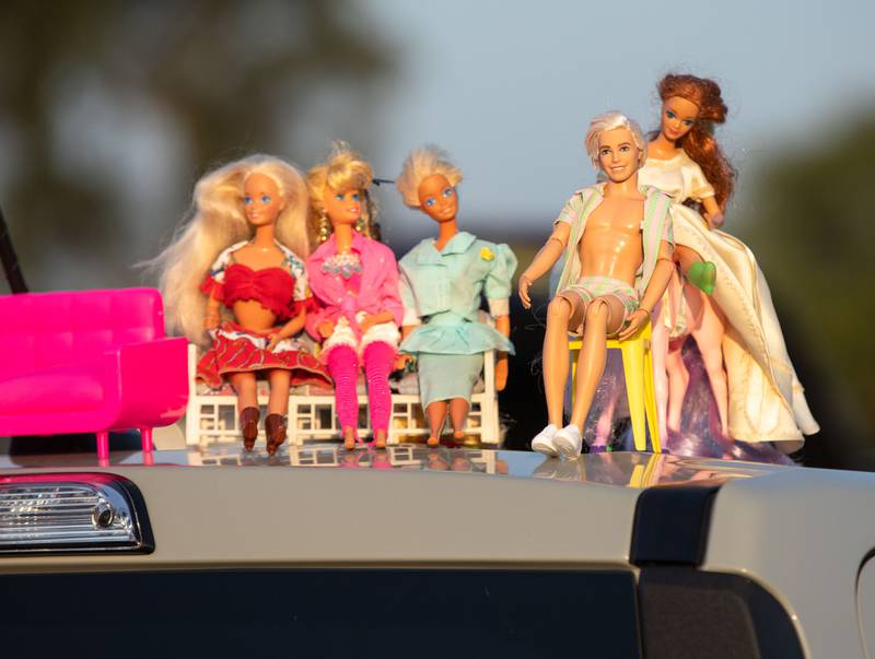 Barbie and Ken dolls posed atop a car to watch the "Barbie" movie that premiered at the McHenry Outdoor Theater on Friday,  July 21, 2023.