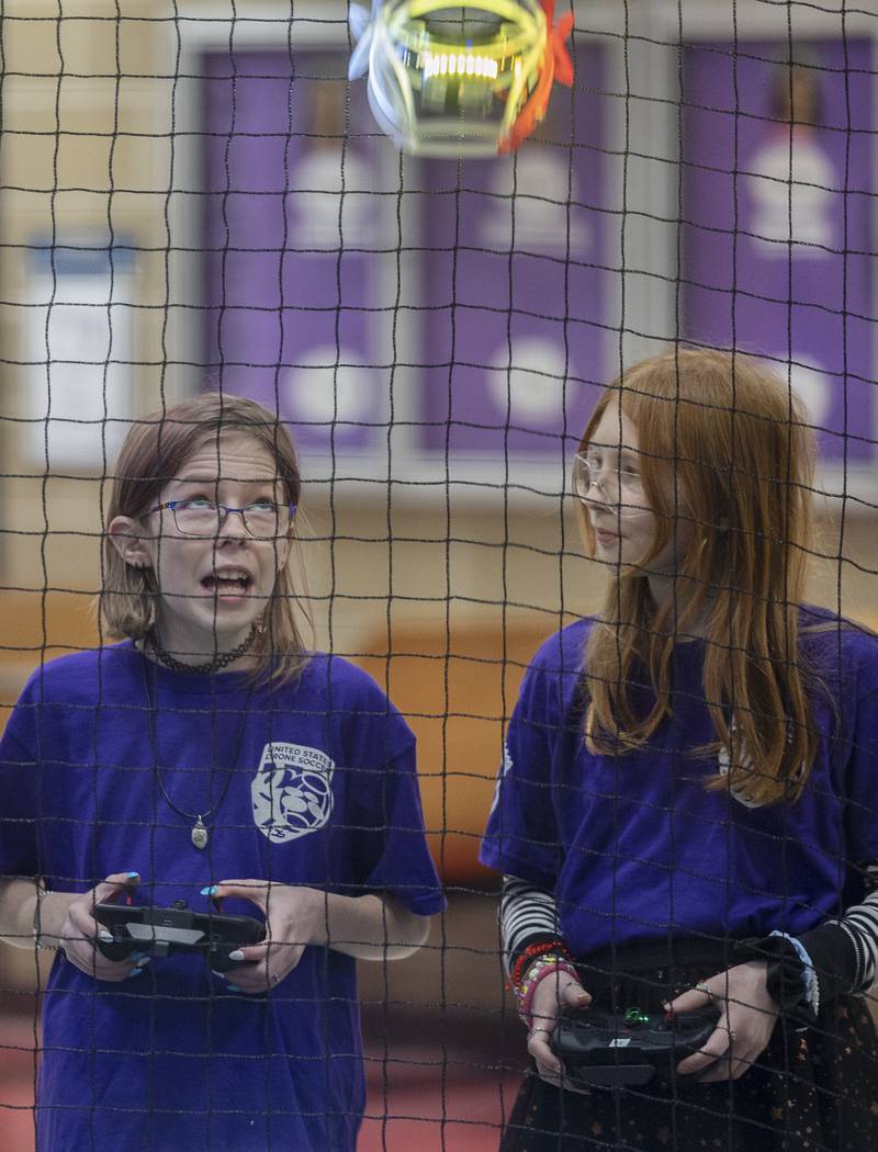 Aislinn Bennett (left) and Genevieve Haag, both 11, fly their drones during the scrimmage Wednesday, Jan. 25, 2024. Reagan Middle School’s three teams and Dixon high’s one team faced off in a first time dual meet.