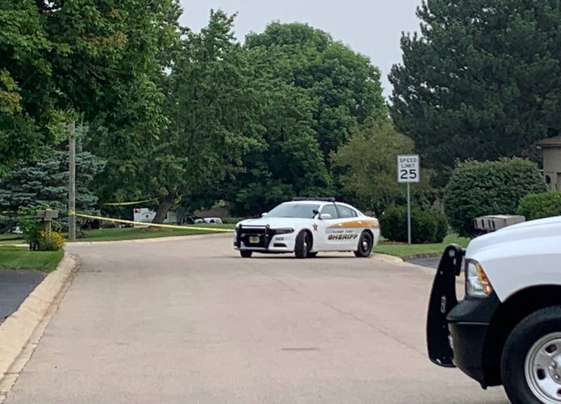 Law enforcement gather Wednesday, Aug. 9, 2023, on Wild Plum Road near Crystal Lake where the McHenry County Sheriff's Office said four people were shot and it was conducting a death investigation.