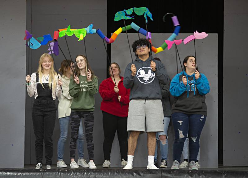 Actors rehearse an underwater scene filled with bright and colorful fish as part of Rock Falls high’s “Seussical the Musical.”