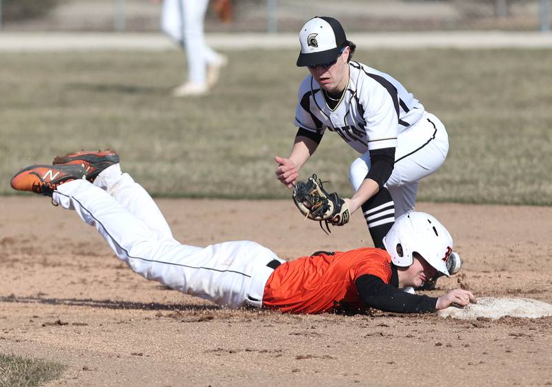 Sycamore's Addison Peck applies the tag to Harlem's Hayden Henderson on a pickoff attempt during their game Monday, March 27, 2023, at the Sycamore Community Park. Henderson was safe on the play.