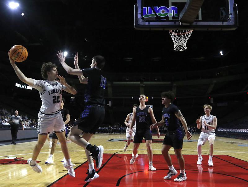Cary-Grove's Ryan Boutwell passes the ball as he is defended by Burlington Central's Patrick Magan during a Fox Valley Conference basketball game on Tuesday, Jan. 14, 2025, at Now Arena in Hoffman Estates.