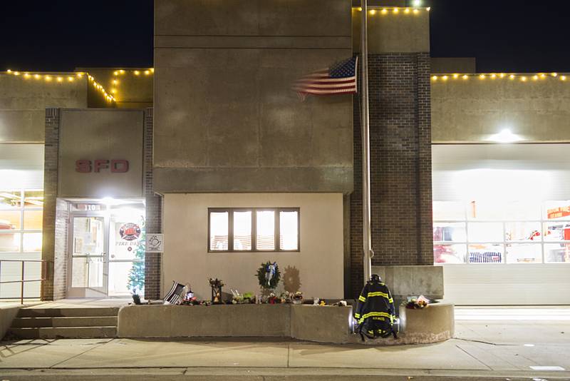 A flag flies at half staff above the memorial at the Sterling Fire Department for fallen firefighter Garrett Ramos. A visitation for Ramos will be held Wednesday and the funeral on Thursday.